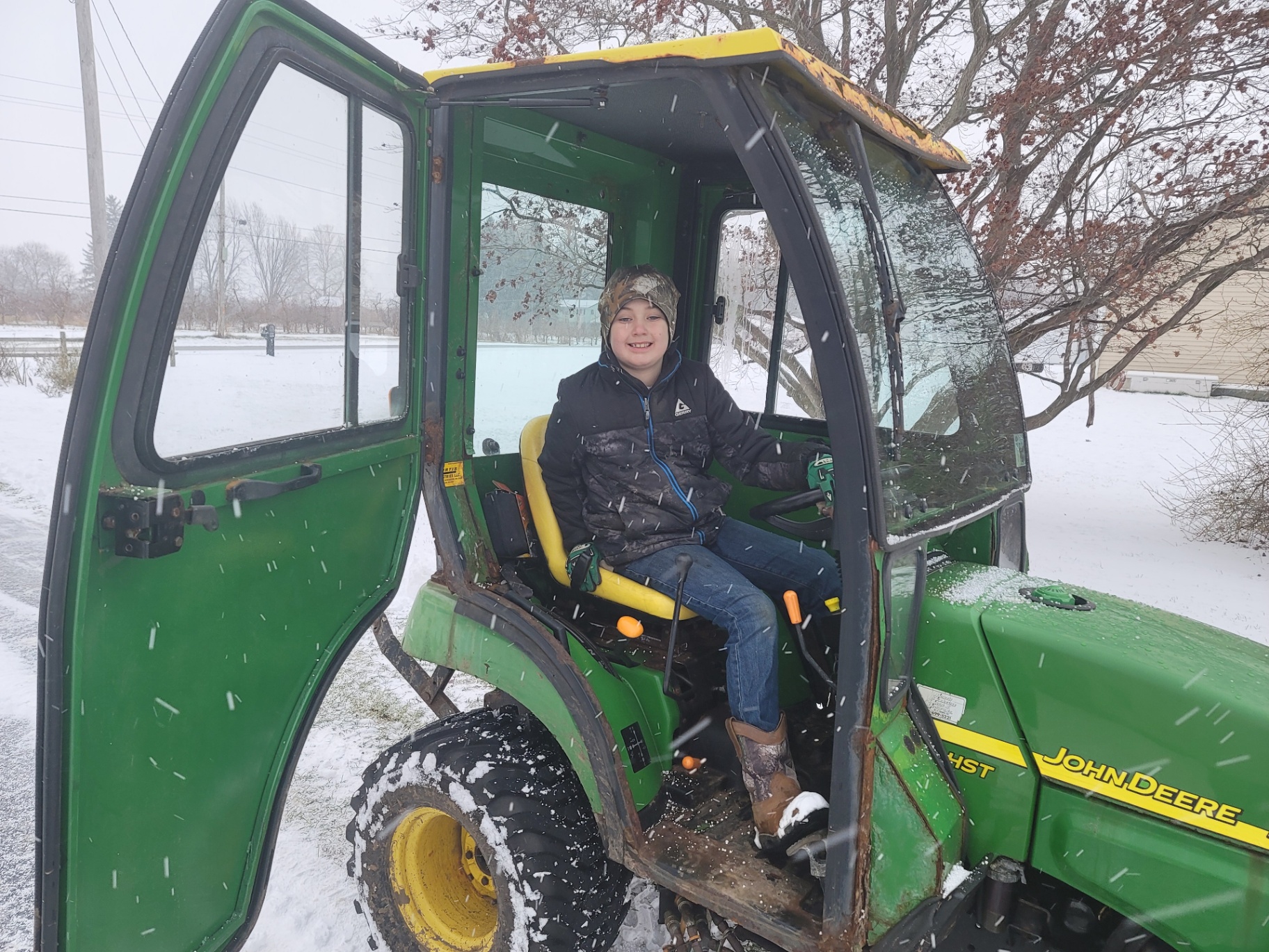 Casen in the John Deere tractor plowing snow