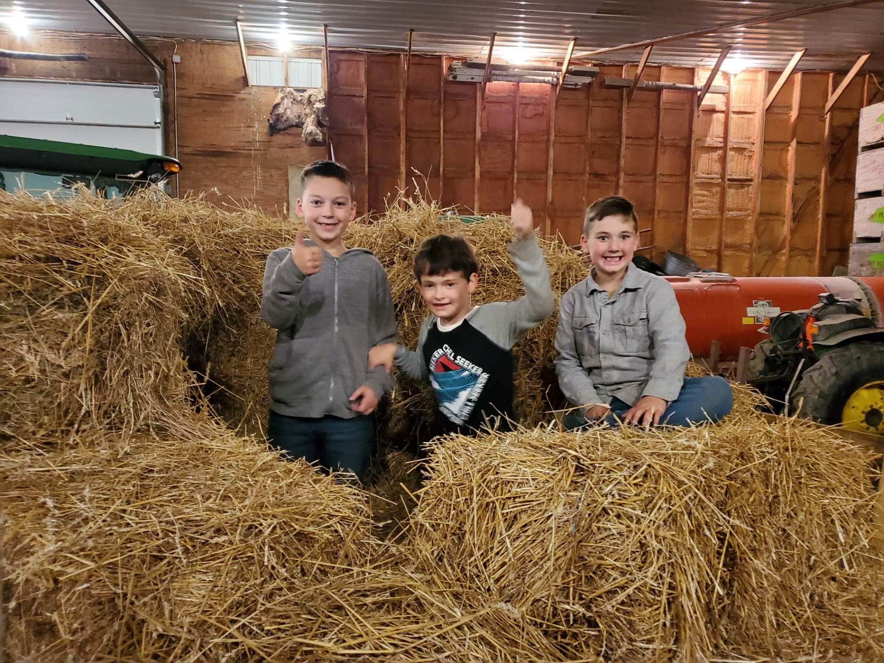 Carter, Casen and a friend on the hay bales in the barn