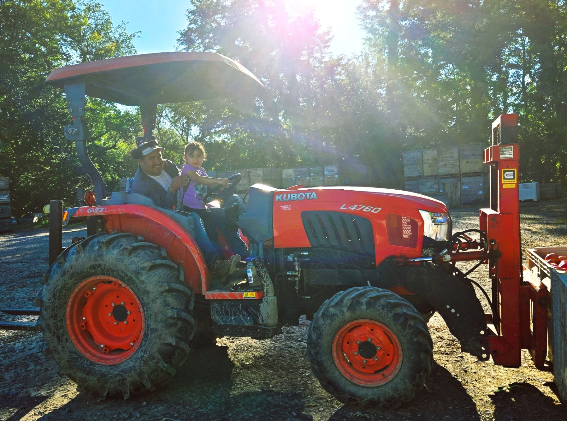 Manuel and his daughter Dariana on the tractor during harvest