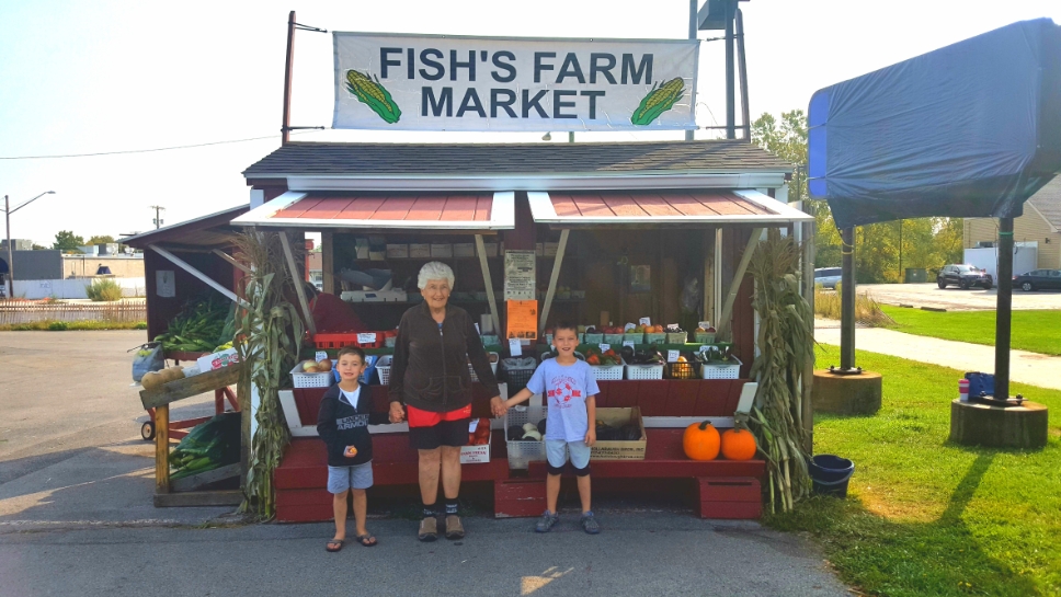 Great Grandma Clara Fish Farrell with her great-grandsons Carter and Casen at her farm stand in Canandaigua
