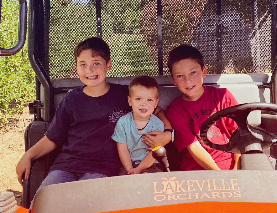Carter, Casen and their little cousin in the Lakeville Orchards UTV